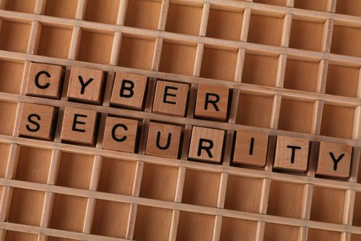 Wooden letter tiles spelling cyber security
