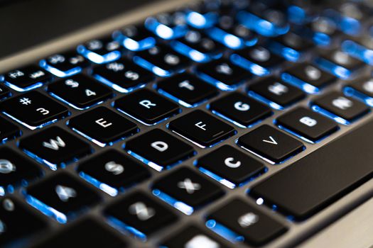 Close-up of a backlit laptop keyboard